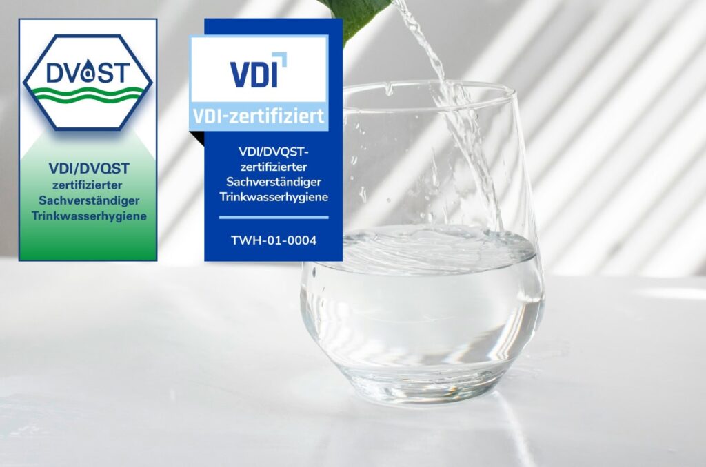 VDI/DVQST-Zertifizierungssiegel für Sachverständige der Trinkwasserhygiene, neben einem Glas Wasser – Qualität und Expertise von LINDEN TEAM